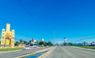 Cancun Mexico 13. January 2022 Typical street road and cityscape with cars and buildings of Cancun in Quintana Roo Mexico.