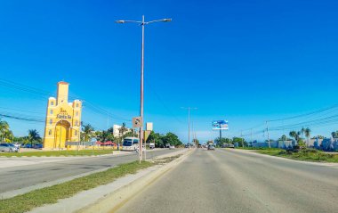 Cancun Mexico 13. January 2022 Typical street road and cityscape with cars and buildings of Cancun in Quintana Roo Mexico.