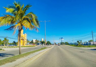 Cancun Mexico 13. January 2022 Typical street road and cityscape with cars and buildings of Cancun in Quintana Roo Mexico.