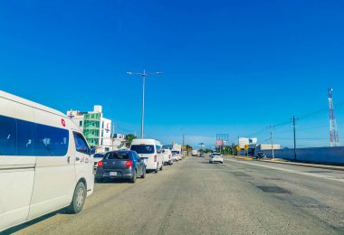 Cancun Mexico 13. January 2022 Typical street road and cityscape with cars and buildings of Cancun in Quintana Roo Mexico.