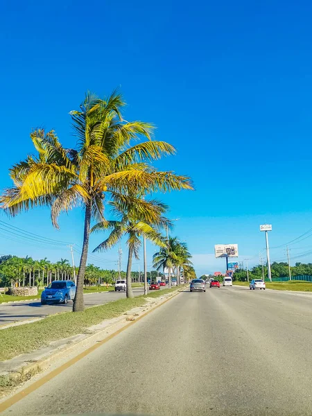 Cancun Mexico 13. January 2022 Typical street road and cityscape with cars and buildings of Cancun in Quintana Roo Mexico.