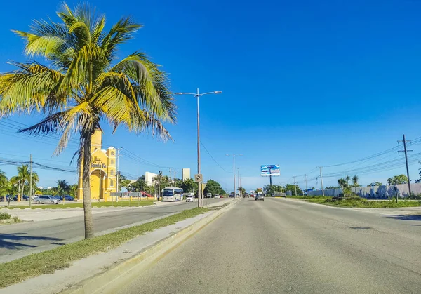 Cancun Mexico 13. January 2022 Typical street road and cityscape with cars and buildings of Cancun in Quintana Roo Mexico.