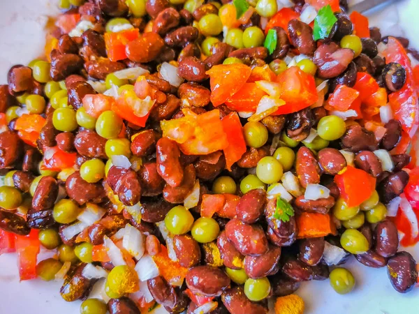 Vegetable dish soup with beans peas potatoes onions tomato and garlic on a white plate bowl with fork or spoon in Mexico.