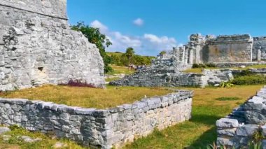 Ancient Tulum ruins Mayan site with temple ruins pyramids and artifacts in the tropical natural jungle forest palm and seascape panorama view in Tulum Mexico.