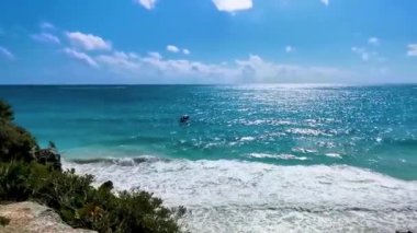 Ancient Tulum ruins Mayan site with temple ruins pyramids and artifacts in the tropical natural jungle forest palm and seascape panorama view in Tulum Mexico.