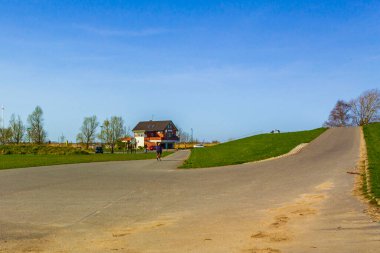 Lower Saxony Germany 10. April 2011 Beautiful wadden sea tidelands coast beach water and dike landscape panorama with walking path at the Wesertunnel in Loxstedt Cuxhaven Lower Saxony Germany.