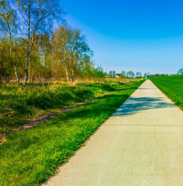 Beautiful wadden sea tidelands coast beach water and dike landscape panorama with walking path at the Wesertunnel in Loxstedt Cuxhaven Lower Saxony Germany.