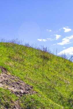 Excavated sand mountains and rubble piles quarry lake dredging pond lake with blue sky and landscape nature forest panorama view in Eggestedt Schwanewede Osterholz Lower Saxony Germany.