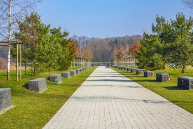 Natural beautiful panorama view with lake river walking pathway and green plants trees in the forest of Speckenbuetteler Park in Lehe Bremerhaven Germany.