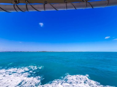 Boat trip tour from Cancun to Island Mujeres Isla Contoy and Whale shark tour with natural tropical seascape panorama and blue turquoise and green clear water view from boat in Quintana Roo Mexico.