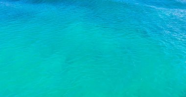 Beautiful blue and turquoise water waves ocean and sea texture pattern of Cancun in Quintana Roo Mexico.