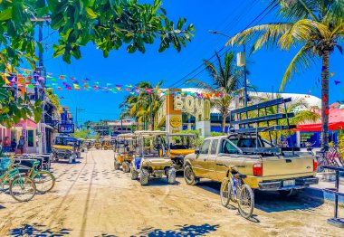 Holbox Mexico 16. May 2022 Golf cart buggy cars carts taxi on muddy sandy street road in the village and at the beach on Holbox island Mexico.