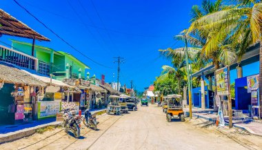 Holbox Mexico 16. May 2022 Golf cart buggy cars carts taxi on muddy sandy street road in the village and at the beach on Holbox island Mexico.