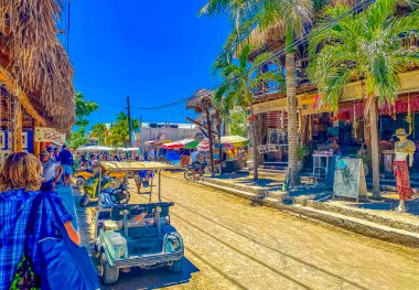 Holbox Mexico 16. May 2022 Golf cart buggy cars carts taxi on muddy sandy street road in the village and at the beach on Holbox island Mexico.