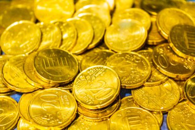 Saved euro coins and bills notes on blue background in Bremerhaven Germany.