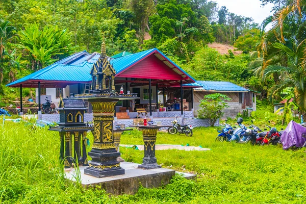 Colorful decorated holy ghost house and holy shrine or small temple in the garden yard street road village in Sakhu Thalang on Phuket island Thailand in Southeastasia Asia.