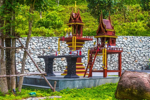 Colorful decorated holy ghost house and holy shrine or small temple in the garden yard street road village in Sakhu Thalang on Phuket island Thailand in Southeastasia Asia.