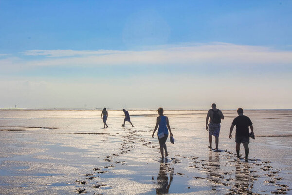 Cuxhaven Germany 11. July 2010 Seascape beach and mudflats hiking with blue sky on the North Sea coast in Wremen Wursten Cuxhaven Lower Saxony Germany.
