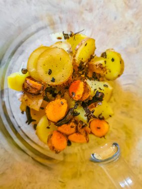 Glass or cup pot with hot ginger tea on a wooden table in Mexico.