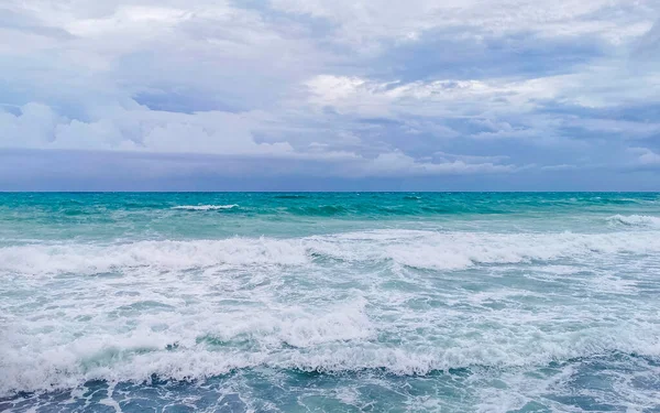 Hurricane 2021 thunderstorm tropical storm with the view on high strong waves wind and dark clouds from the pier Muelle Constituyentes in Playa del Carmen Quintana Roo Mexico.