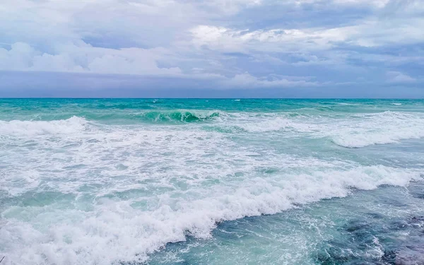 Hurricane 2021 thunderstorm tropical storm with the view on high strong waves wind and dark clouds from the pier Muelle Constituyentes in Playa del Carmen Quintana Roo Mexico.