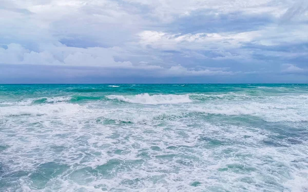 Hurricane 2021 thunderstorm tropical storm with the view on high strong waves wind and dark clouds from the pier Muelle Constituyentes in Playa del Carmen Quintana Roo Mexico.