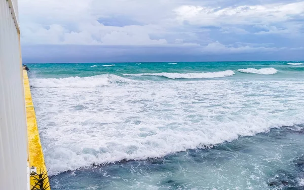 Hurricane 2021 thunderstorm tropical storm with the view on high strong waves wind and dark clouds from the pier Muelle Constituyentes in Playa del Carmen Quintana Roo Mexico.