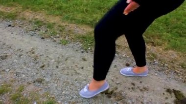 Woman has sheep shit poop stuck to shoe in Lower Saxony Germany.