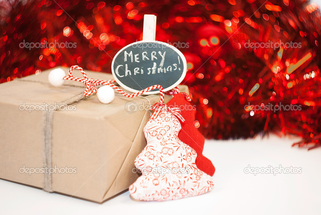 Wrapped Christmass gift box on red sparkling background