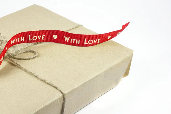 Gift box with red ribbon "With love" on a white background — Stock Photo, Image