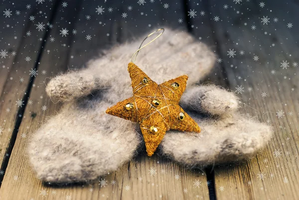 Mittens with Cristmas decoration on wooden background — Stock Photo, Image