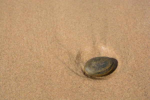 Stone on a sandy beach — Stock Photo, Image