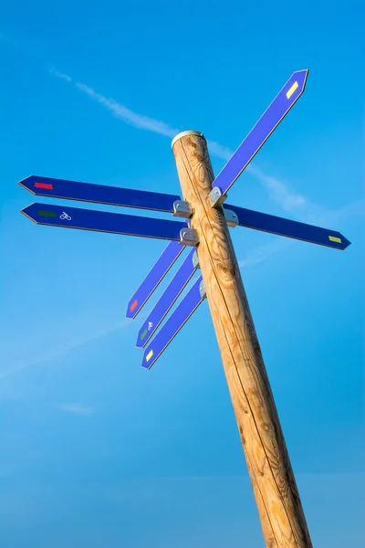 Dřevěná tyč s mnoha směr šipky — Stock fotografie