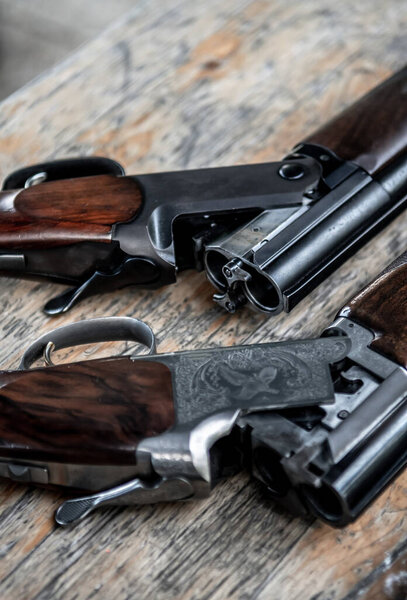 Деталь открытых охотничьих винтовок, лежащих на столе
