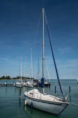 Modern Sail Boat Anchors In Calm Harbor On Lake Balaton In Hungary