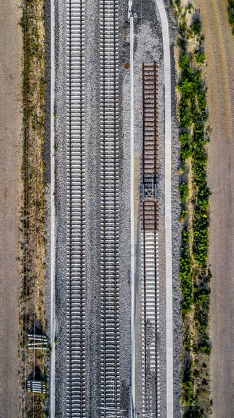 Aerial View Of Railroad Tracks And Gravel Roads in Rural Landscape with Agricultural Areas