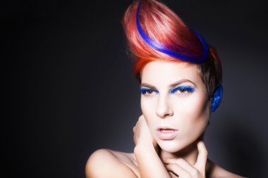 mavi göz farı, mavi kulakları ve üzerinde mavi damarlı kamera ve elleri yakın yüzüne bakarak pembe saçlı genç kişi. siyah arka plan