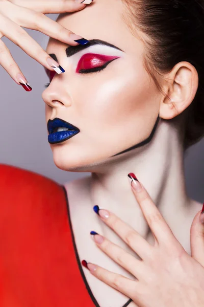 Beautiful brunette woman with creative pop art make up and geometric nail style, black lines and closed eyes — Stock Photo, Image