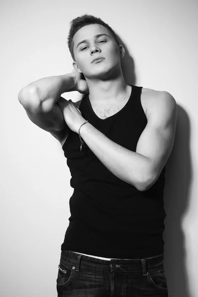 Handsome gorgeous young man in shirt indoor smiling. Black and white — Stock Photo, Image