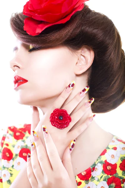 Brunette woman in yellow and red dress with poppy flower in her hair, poppy ring and creative nails, closed eyes on white background — Stock Photo, Image