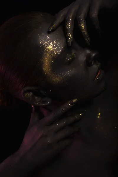 Close up portrait of a Woman on black background with the glitters and sparkles all over the black skin — Stock Photo, Image