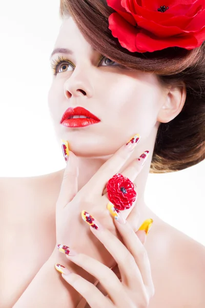 Mujer morena con flor de amapola en el pelo, anillo de amapola y uñas creativas sobre fondo blanco — Foto de Stock