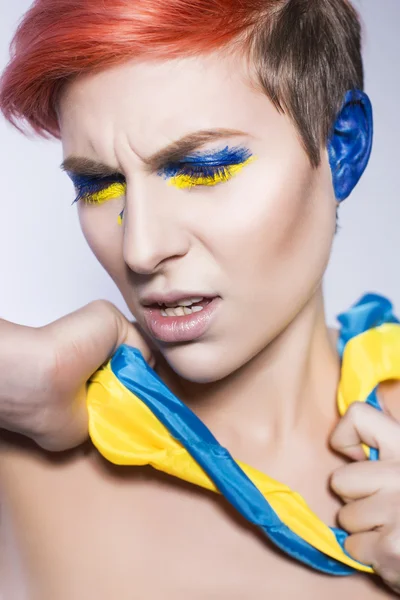 Young person closing ears and don't want to listen political lies crying. Ukrainian symbols and colors — Stock Photo, Image