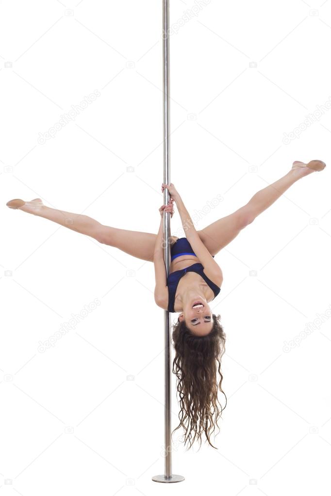 Young beautiful brunette girl doing pole dancing exercise. isolated on white