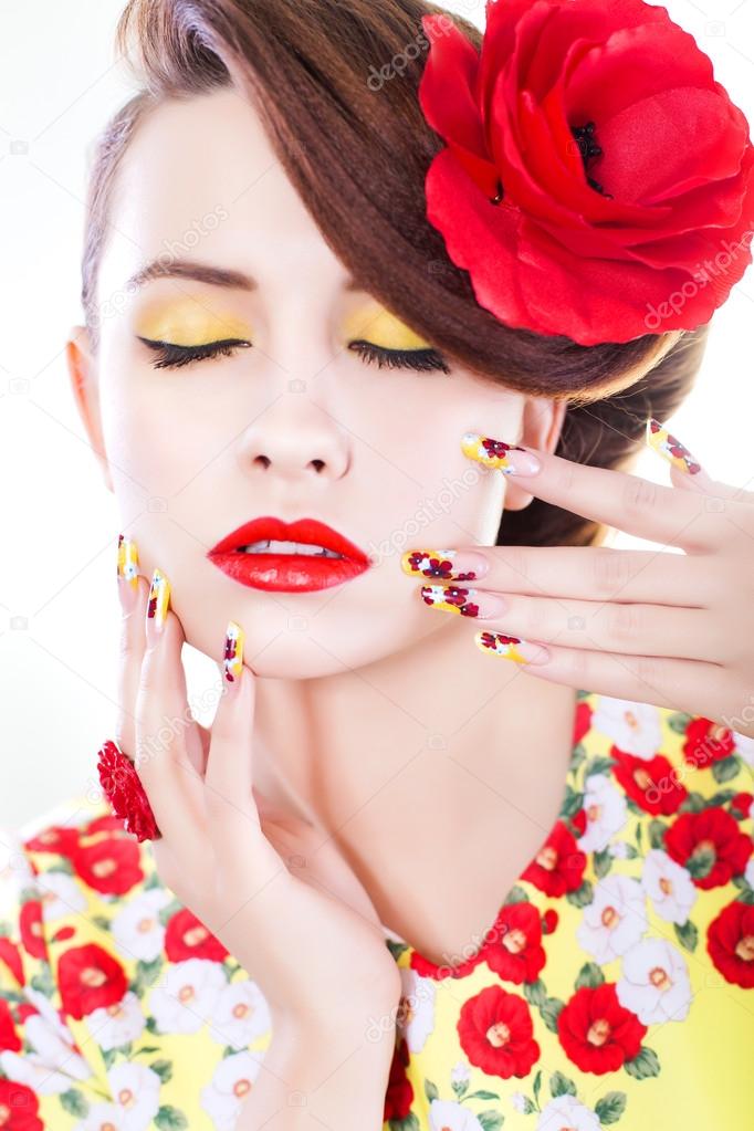 Brunette woman in yellow and red dress with poppy flower in her hair, poppy ring and creative nails, closed eyes on white background