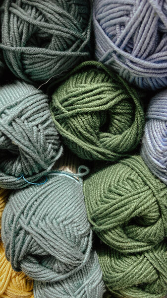 balls of green and gray yarn