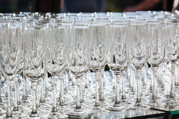 Empty glass transparent wine glasses on a table, catering background concept.