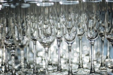 Restoranda bir grup boş ve şeffaf şampanya kadehi. Barmen tarafından şampanya için hazırlanmış temiz bardaklar. Etkinlik hazırlığı için servis, içki için boş bardaklar..
