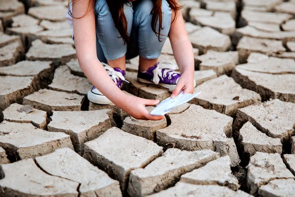 Girl Lowers Paper Boat Dry Cracked Ground Water Crisis Climate — Stock Photo, Image