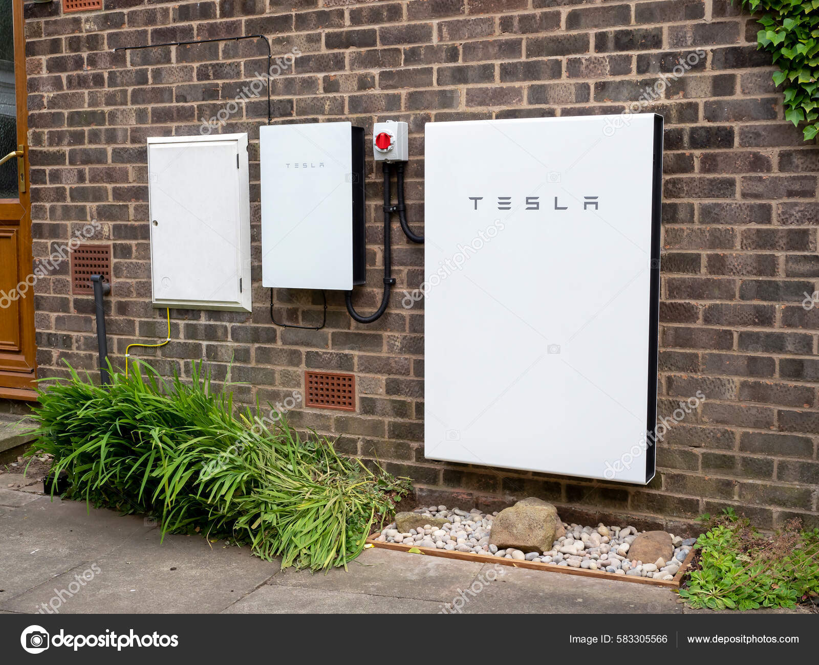 Tesla Powerwall Backup Gateway Installed Brick House Wall Stock tesla-powerwall-backup-gateway-installed-brick-house-wall-stock